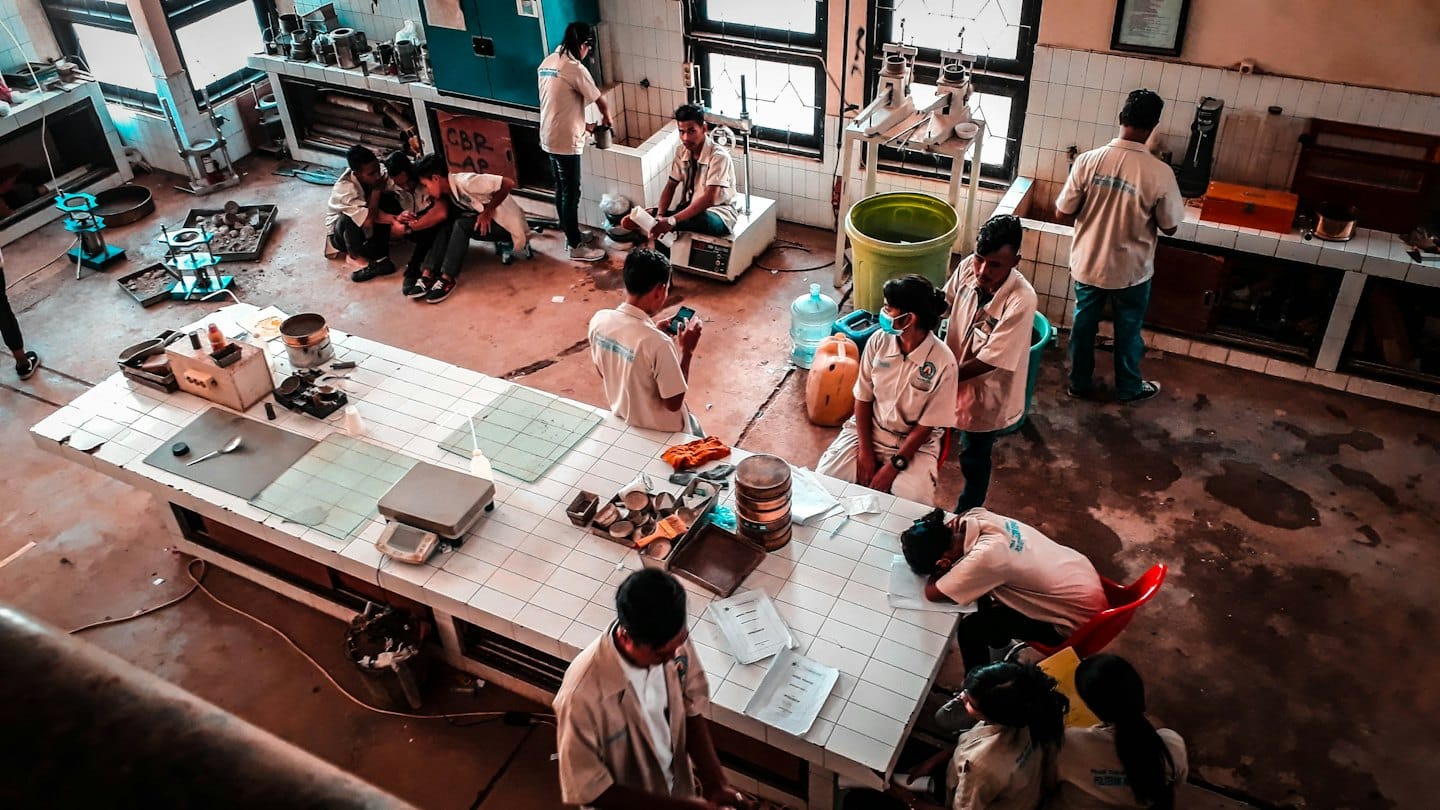 Students work with scientific equipment in a materials testing lab.